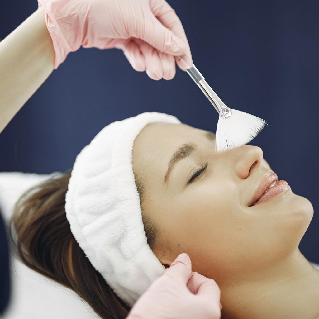 Woman enjoying a relaxing facial treatment at a spa, highlighting skincare and relaxation.