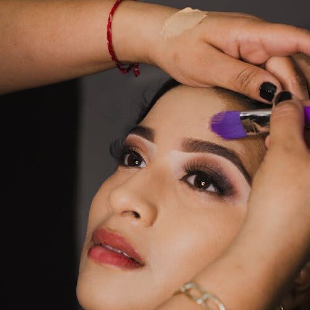Close-up of a woman's face during a professional makeup application session.
